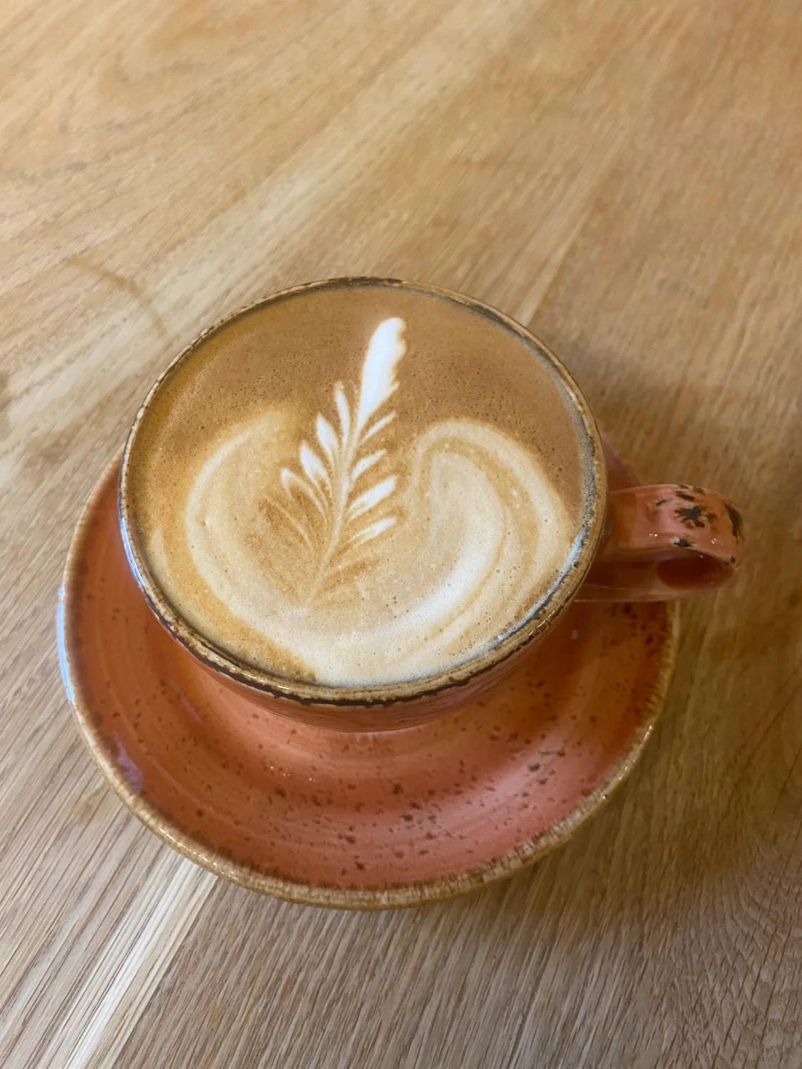 Coffee being prepared at The Loft, with colourful cups and fresh flowers